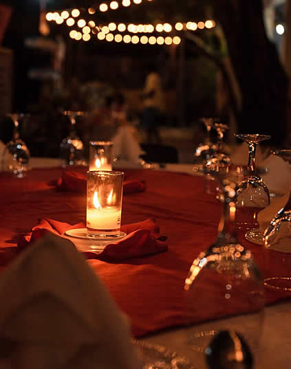 Candlelit outdoor dinner table strung with lights at Bangcogon Restaurant