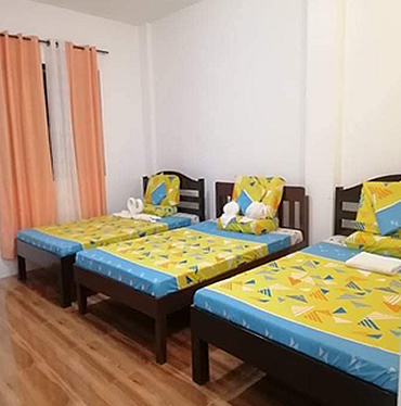 Family Room with three single beds at the BRR Annex