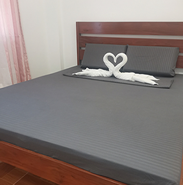 Queen Room with towels folded into a heart on the bed